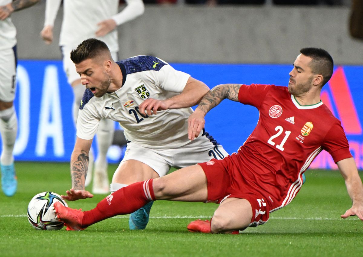 Serbia's midfielder Sergej Milinkovic-Savic (L) and Hungary's defender Endre Botka (R) vie for the ball during the friendly football match Hungary v Serbia in Puskas Arena of Budapest on March 24, 2022. 