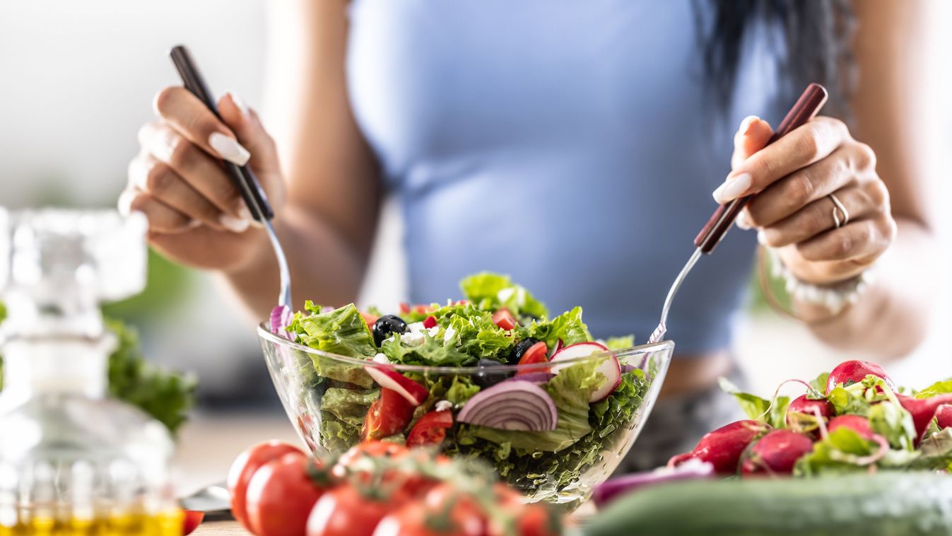 Female,Hands,Mixing,A,Healthy,Spring,Salad,Made,From,Various