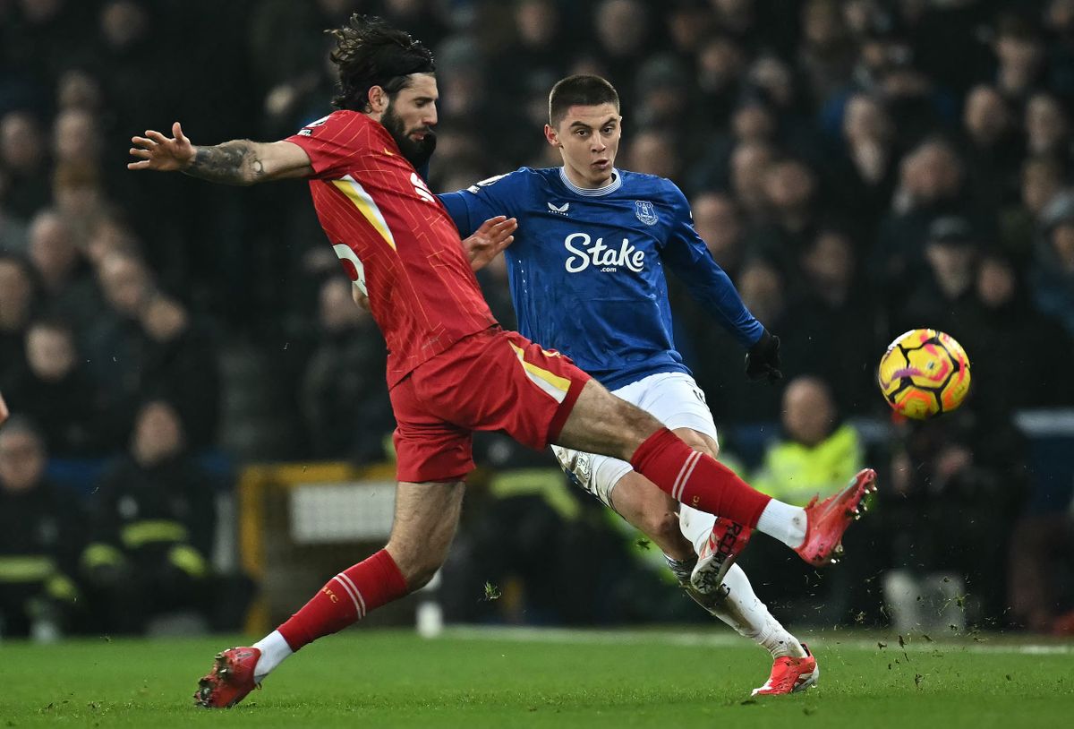 Everton's Ukrainian defender #19 Vitaliy Mykolenko (R) vies with Liverpool's Hungarian midfielder #08 Dominik Szoboszlai during the English Premier League football match between Everton and Liverpool at Goodison Park in Liverpool, north west England on February 12, 2025. 