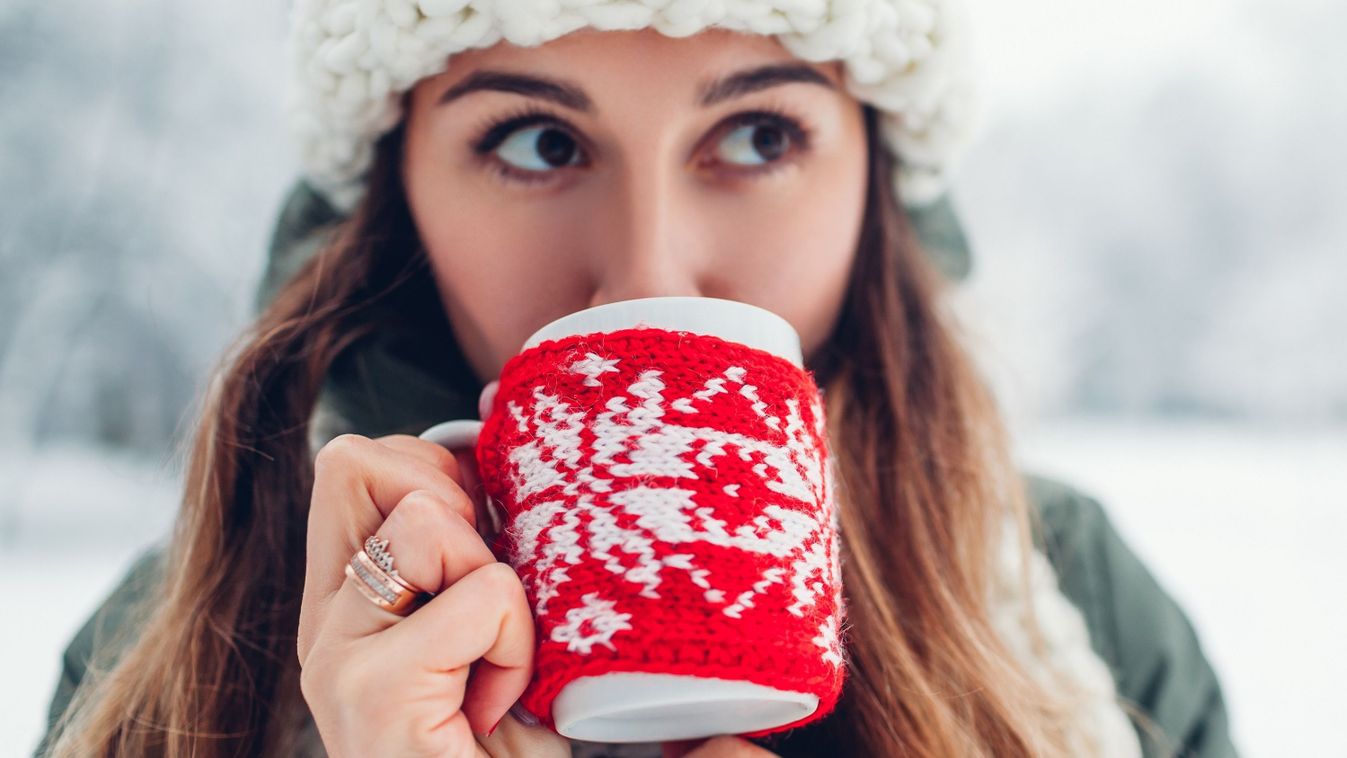 Close,Up,Of,Woman,Drinking,Hot,Tea,Holding,Cup,Dressed