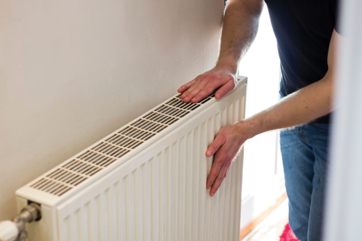 Man,Is,Checking,Radiator,Is,It,Heating.,Man,Warming,His