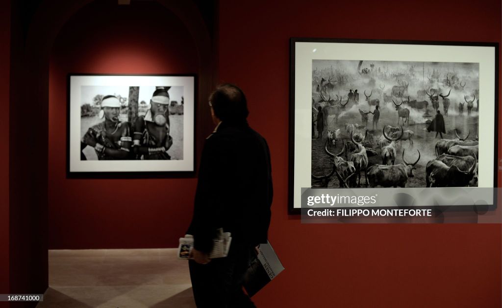 A visitor looks at prints by Brasilian photographer Sebastiao Salgado at the opening of the exhibition titled 'Genesis' in Rome's Ara Pacis museum on May 14, 2013. The exhibition comprising two hundred black and white images of pristine landscapes, wild a