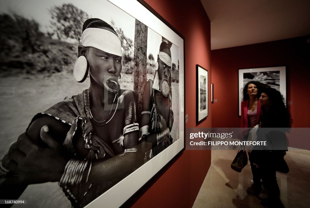 A visitor looks at prints by Brasilian photographer Sebastiao Salgado at the opening of the exhibition titled 'Genesis' in Rome's Ara Pacis museum on May 14, 2013. The exhibition comprising two hundred black and white images of pristine landscapes, wild a