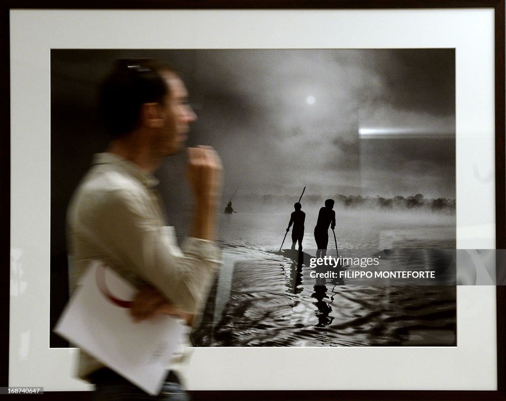 A visitor looks at prints by Brasilian photographer Sebastiao Salgado at the opening of the exhibition titled 'Genesis' in Rome's Ara Pacis museum on May 14, 2013. The exhibition comprising two hundred black and white images of pristine landscapes, wild a
