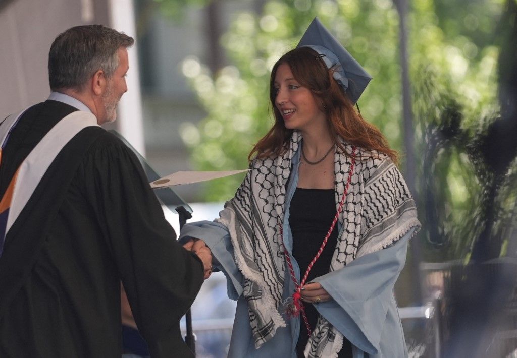 Palestinian student Mohsen Mahdawi walks the graduation stage at Columbia University