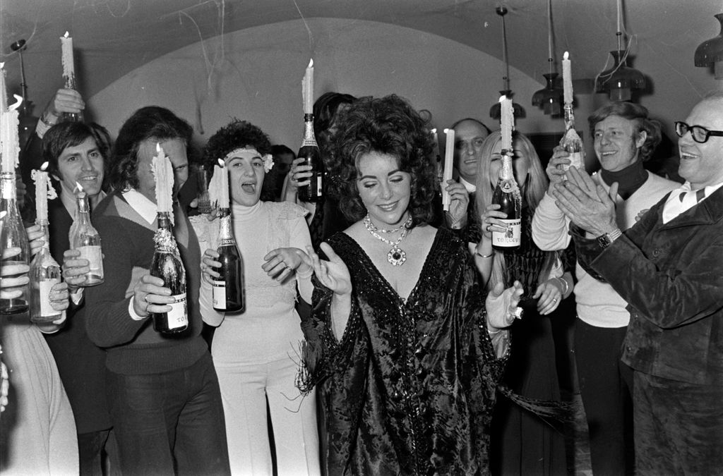 Elizabeth Taylor (C) attends a party during her weekend-long 40th birthday celebration in Budapest, Hungary, on Feb. 26-27, 1972. (Photo by Reginald Gray/WWD/Penske Media via Getty Images)