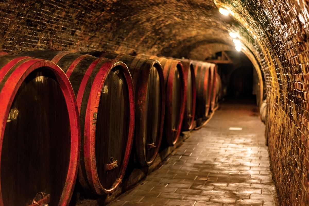 Wooden,Old,Barrels,In,The,Rustic,Wine,Cellar,With,Brick