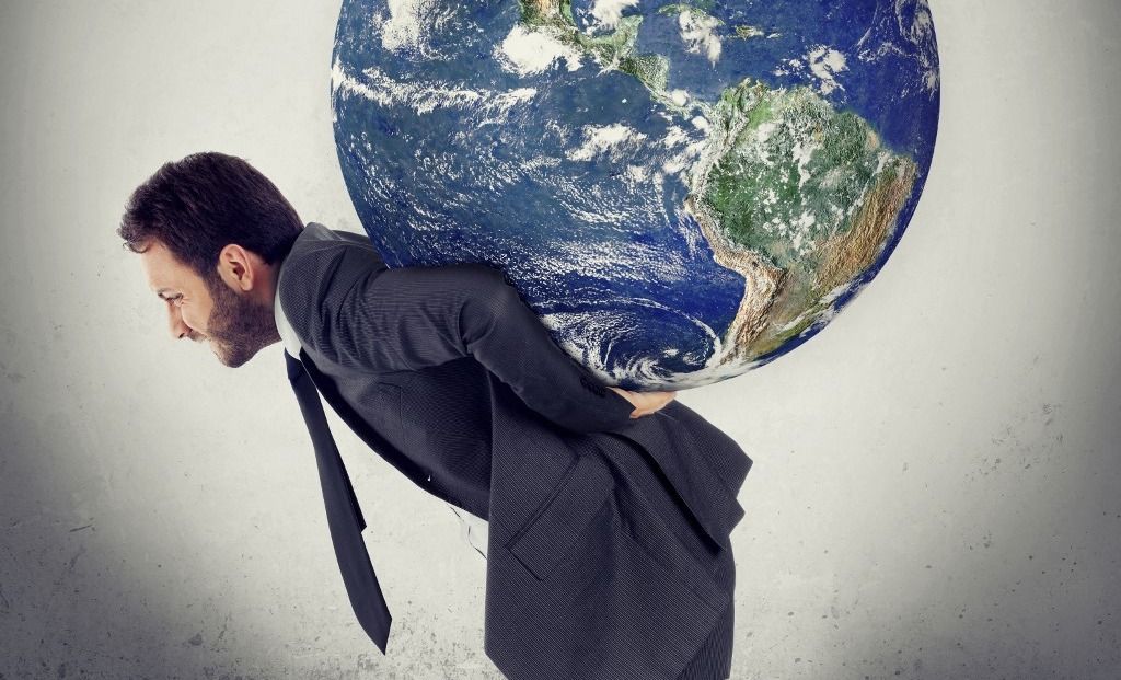 Man carrying planet Earth on his back, composite image