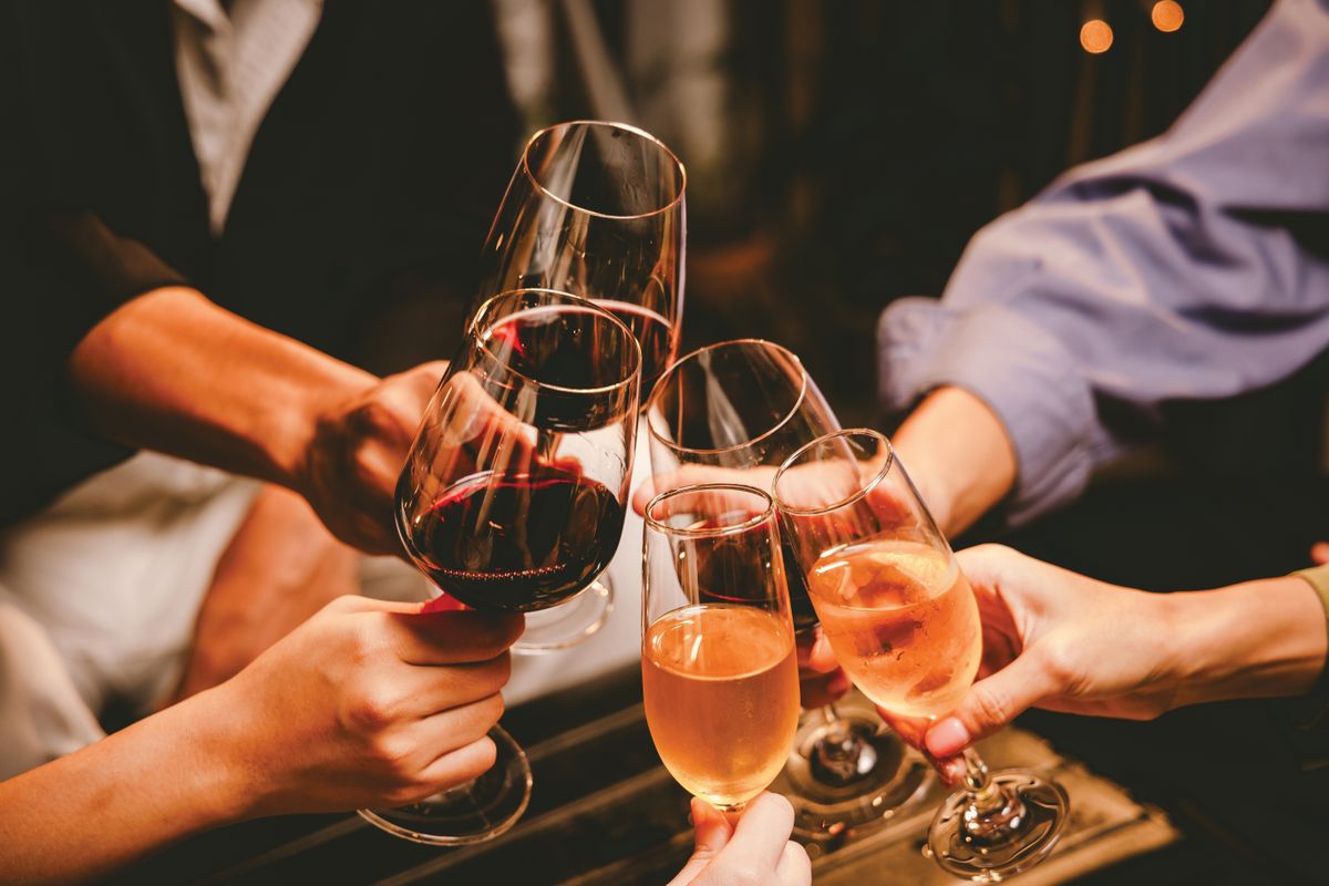 A,Group,Of,Friends,Enjoy,An,Outdoor,Evening,,Drinking,Wine