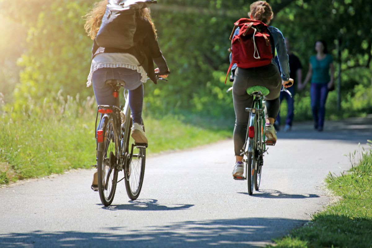 Two,Young,Women,On,A,Bycicle,Tour,Together,,Blur