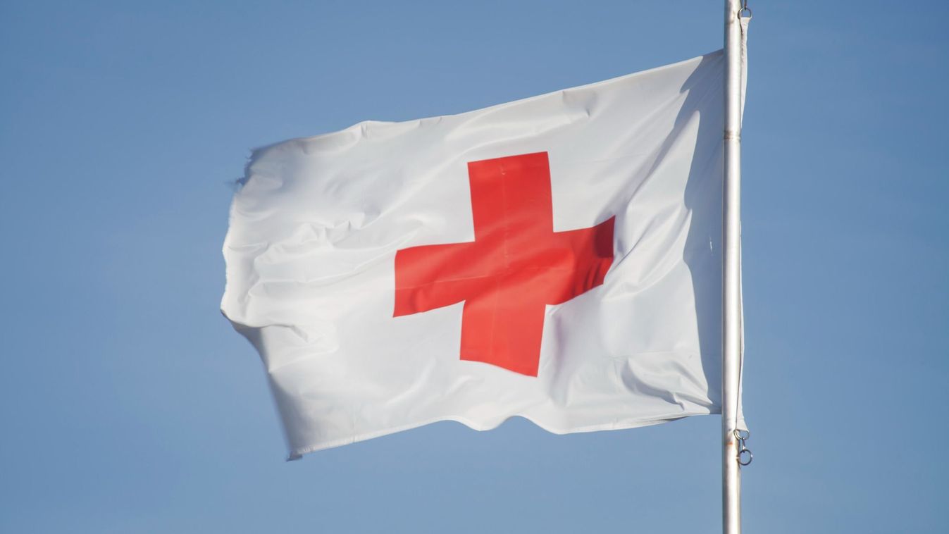 First Aid/Medic Red cross flag and blue sky.
Getty Images