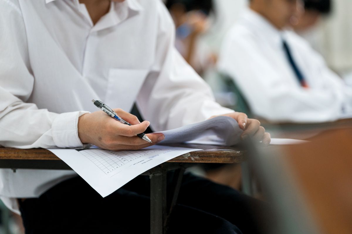 A,Group,Of,Students,Seated,In,Rows,,Writing,On,Exam
