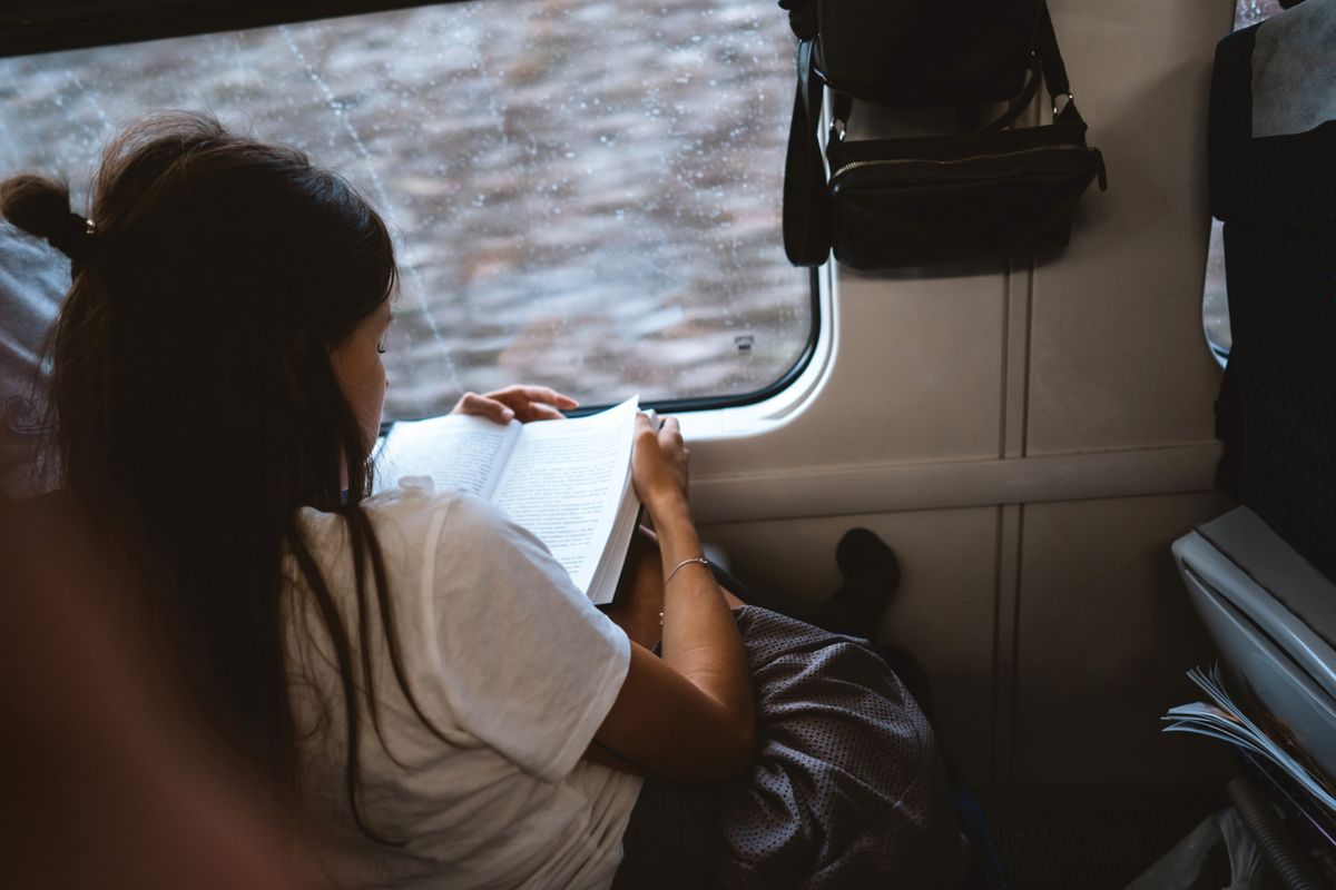 Young,Happy,Woman,Sitting,In,City,Bus