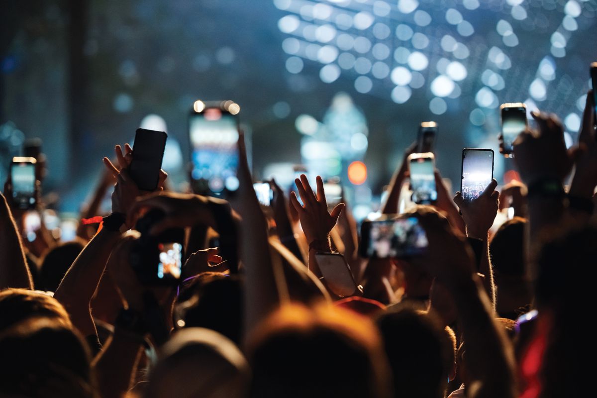 Fans,At,A,Concert,Record,The,Show,On,Their,Smartphones,